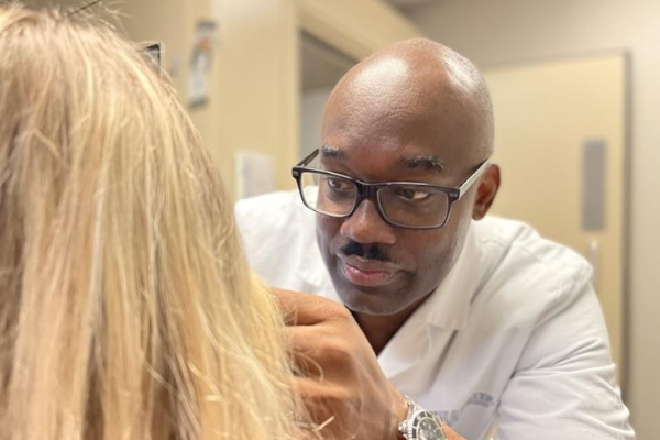 Audiologist Harlan Carroll doing a hearing aid fitting