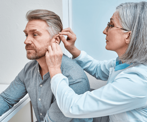 Audiologist treating a patient